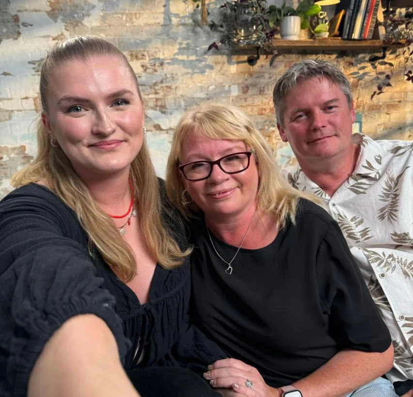 Ellie with her parents, Tara and Simon